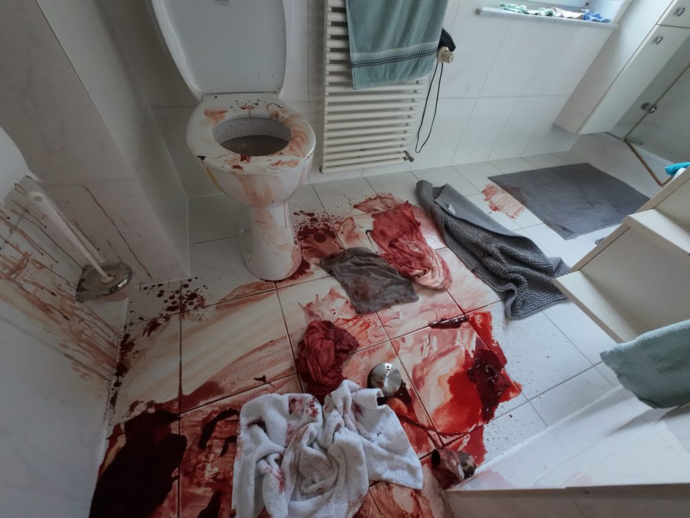 Badezimmer mit Blutspuren und verschmutzten Textilien